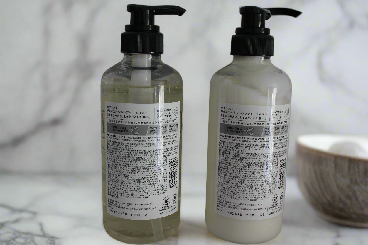 Two bottles  of BOTANIST Botanical set with pump dispensers on a white background in the bathroom